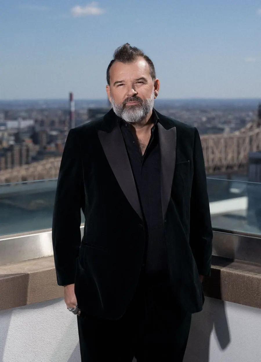 Philippe Cesson on a rooftop above a city skyline